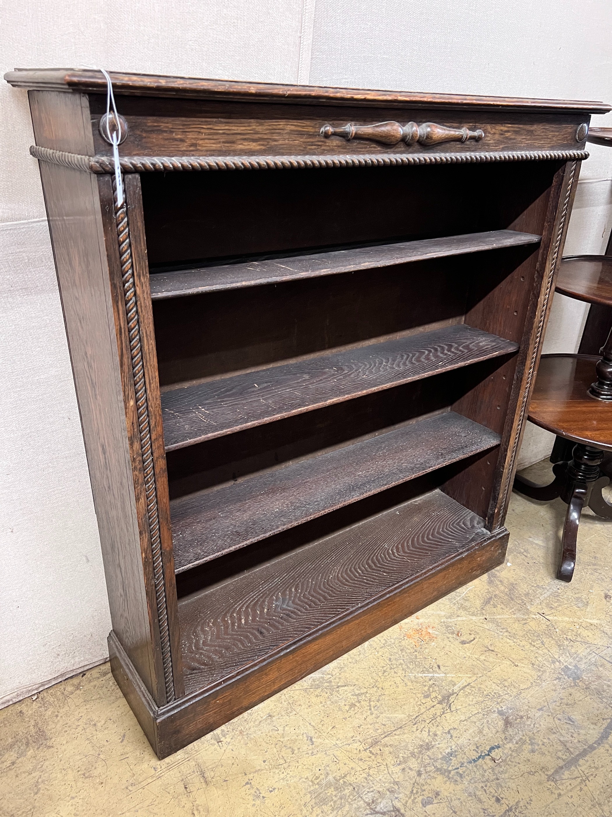 A 1920's oak open bookcase, length 99cm, depth 25cm, height 108cm